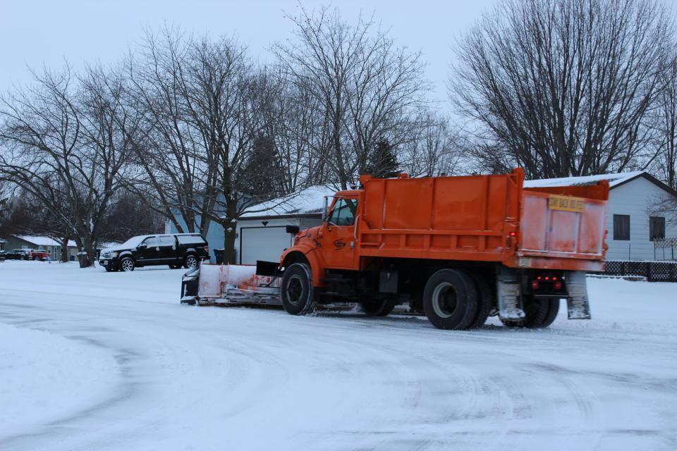 Crews clear sidewalks and roads Wednesday morning in Pulaski after the area received 2-3 inches of snow.