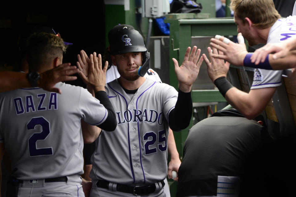 Colorado Rockies' C.J. Cron (25) celebrates with teammates in the dugout after scoring during the seventh inning of a baseball game against the Chicago Cubs, Saturday, Sept. 17, 2022, in Chicago. (AP Photo/Paul Beaty)
