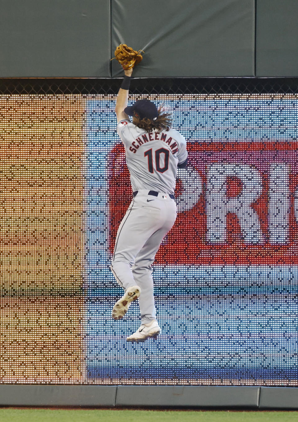 Cleveland Guardians right fielder Daniel Schneemann hits the wall in an attempt to catch a home run by Kansas City Royals' Kyle Isbel during the fourth inning of a baseball game in Kansas City, Mo., Friday, June 28, 2024. (AP Photo/Colin E. Braley)