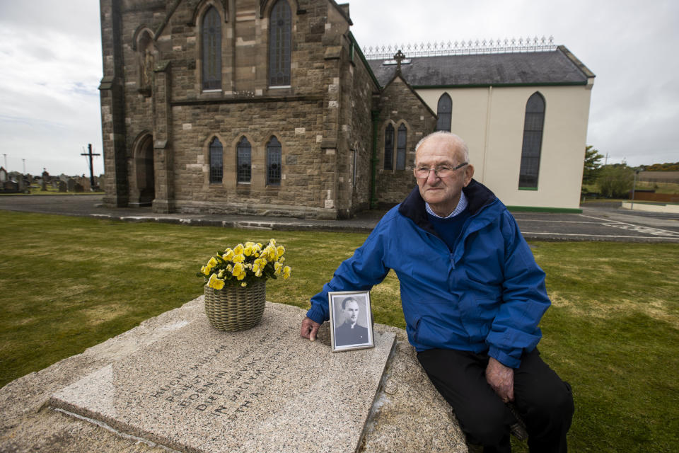 <p>Patsy Mullan, brother of Father Hugh Mullan, visit's his brother's grave at St. Patrick's Church in Portaferry, ahead of the findings tomorrow of the Ballymurphy Inquest. Picture date: Monday May 10 2021.</p>
