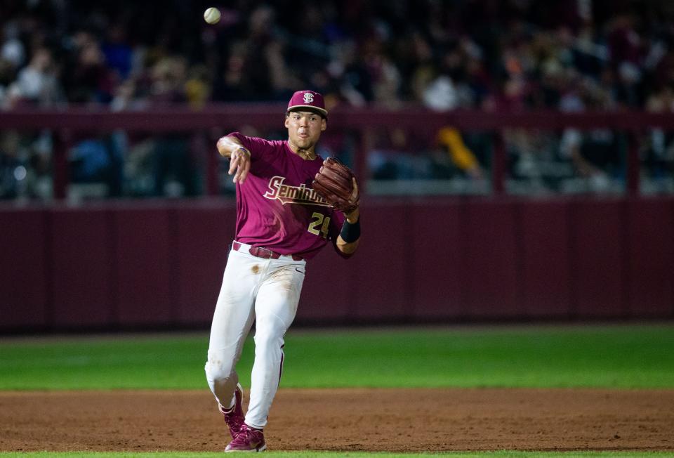 Florida State infielder Cam Smith (24) throws to first. The Florida Gators defeated the Florida State Seminoles 9-5 on Tuesday, March 21, 2023. 