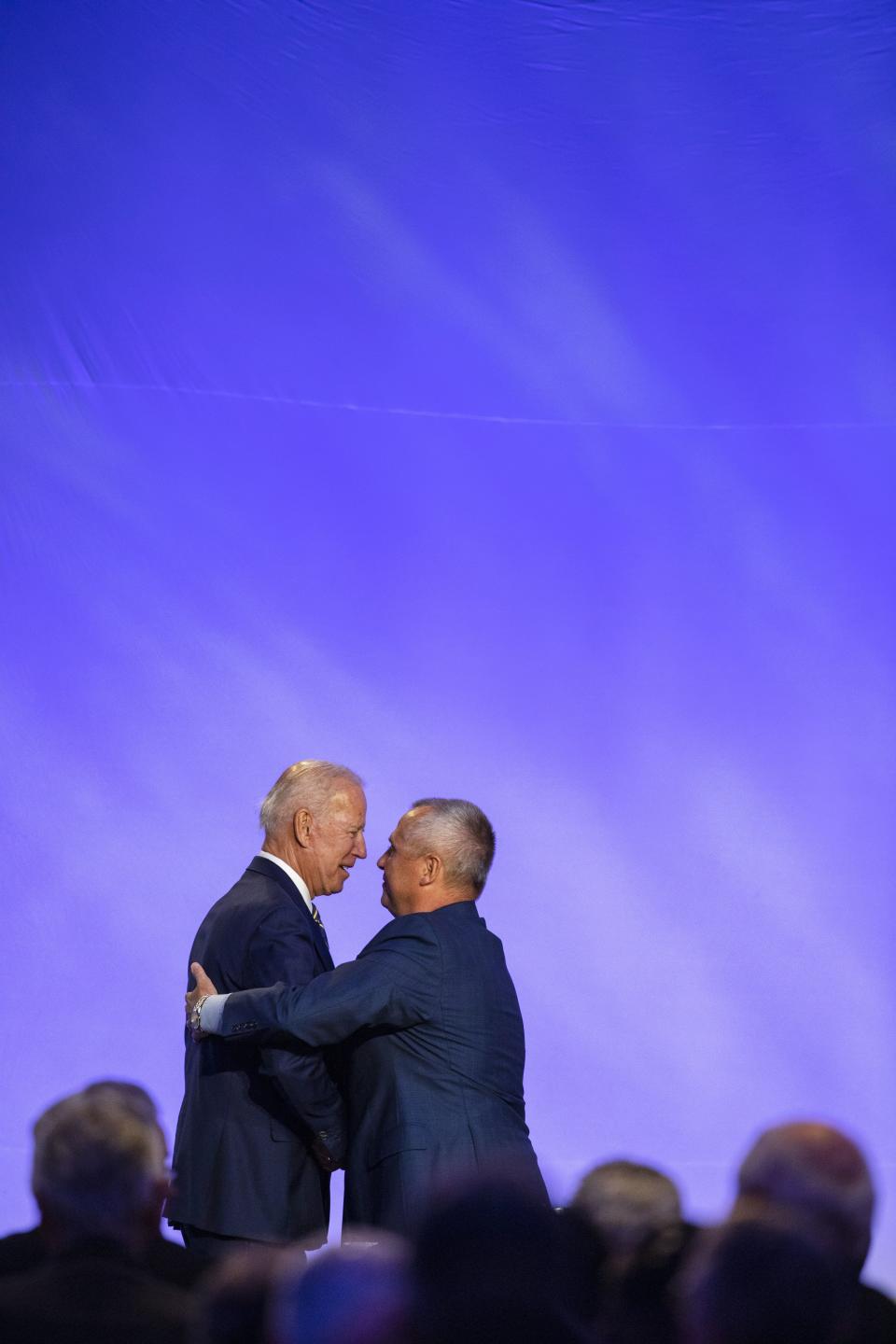 WASHINGTON, DC - APRIL 05: Former Vice President Joe Biden and Brotherhood of Electrical Workers President Lonnie Stephenson greet on stage at the International Brotherhood of Electrical Workers Construction and Maintenance conference on April 05, 2019 in Washington, DC. Former Vice President Joe Biden on Friday called President Donald Trump a "tragedy in two acts" for the way he characterizes people and is consumed with personal grievances. (Photo by Tasos Katopodis/Getty Images) ORG XMIT: 775324810 ORIG FILE ID: 1140627678