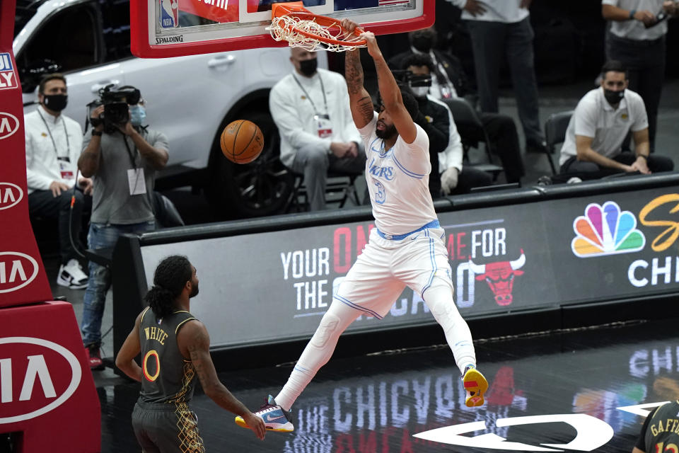 Los Angeles Lakers forward Anthony Davis dunks as Chicago Bulls guard Coby White watches during the first half of an NBA basketball game in Chicago, Saturday, Jan. 23, 2021. (AP Photo/Nam Y. Huh)