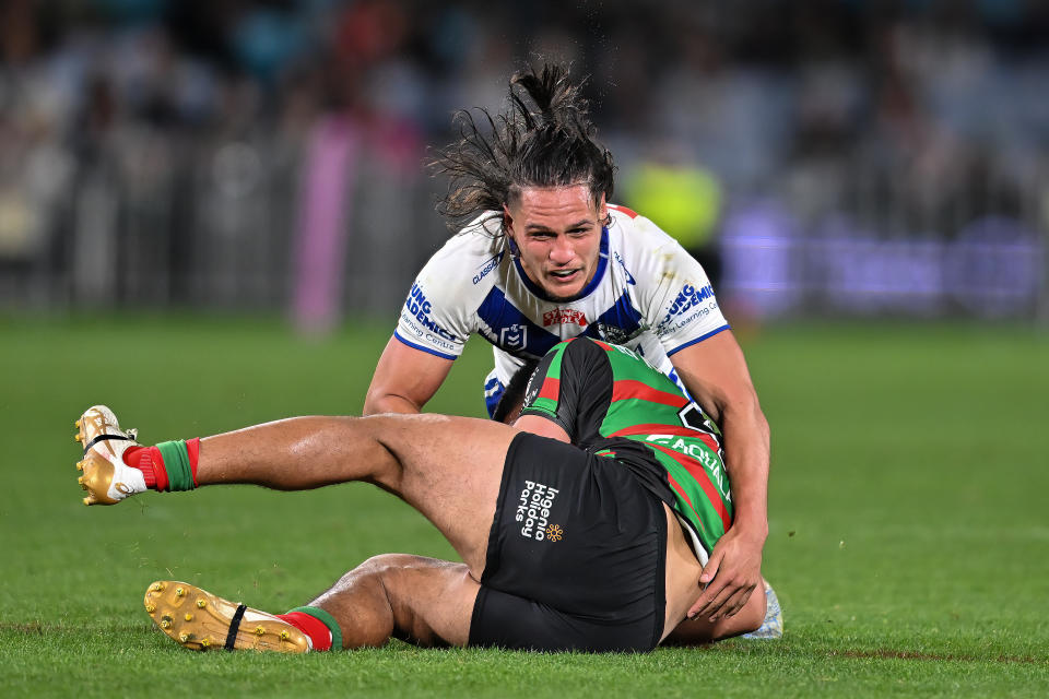 SYDNEY, AUSTRALIA - JULY 08: Taane Milne of the Rabbitohs is tacked by Jackson Topine of the Bulldogs during the round 19 NRL match between South Sydney Rabbitohs and Canterbury Bulldogs at Accor Stadium on July 08, 2023 in Sydney, Australia. (Photo by Izhar Khan/Getty Images)