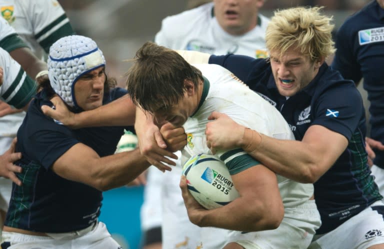 South Africa's lock Eben Etzebeth (C) holds off Sctoland's flanker Blair Cowan (L) during their Rugby World Cup Pool B match, at St James' Park in Newcastle-upon-Tyne, on October 3, 2015