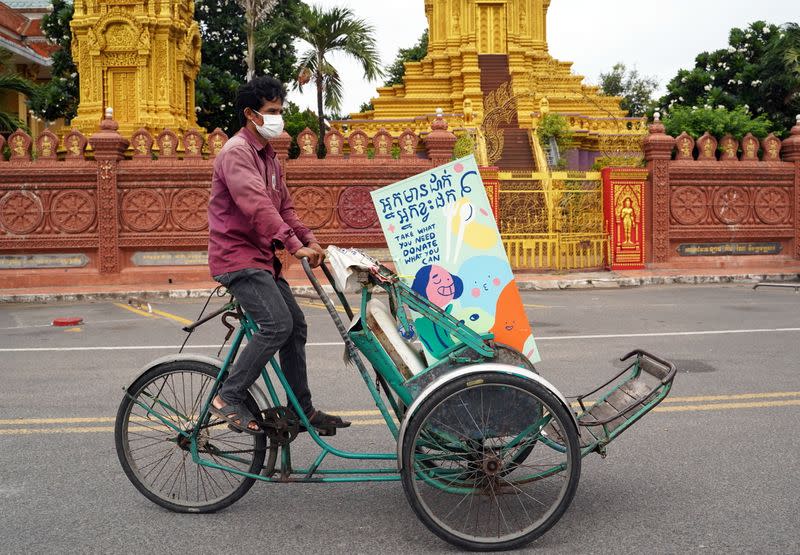 Cambodian cyclo-drivers pedal mobile food banks to deliver aid