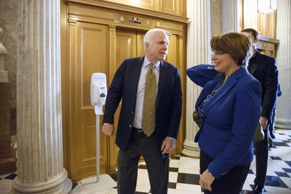 Senate Armed Services Committee Chairman Sen. John McCain, R-Ariz., left, and Sen. Amy Klobuchar, D-Minn., head to the Senate floor on Capitol Hill in Washington, Friday, Feb. 27, 2015, as Congress closed in on approving a short-term spending bill for the Homeland Security Department that would avert a partial agency shutdown hours before it was to begin. The legislation also leaves intact Obama administration executive actions on immigration that Republicans have vowed to overturn.  (AP Photo/J. Scott Applewhite)