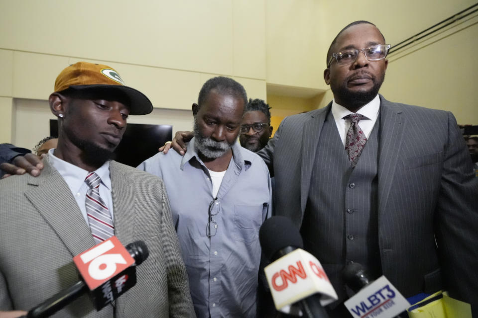 Melvin Jenkins, center, his son Michael Corey Jenkins, left, listen as their lead civil attorney Malik Shabazz, right, comments on the sentencing of six former Mississippi law enforcement officers for the racially motivated torture of the younger Jenkins, and his friend, Eddie Terrell Parker, Wednesday, April 10, 2024, in Brandon, Miss. (AP Photo/Rogelio V. Solis)