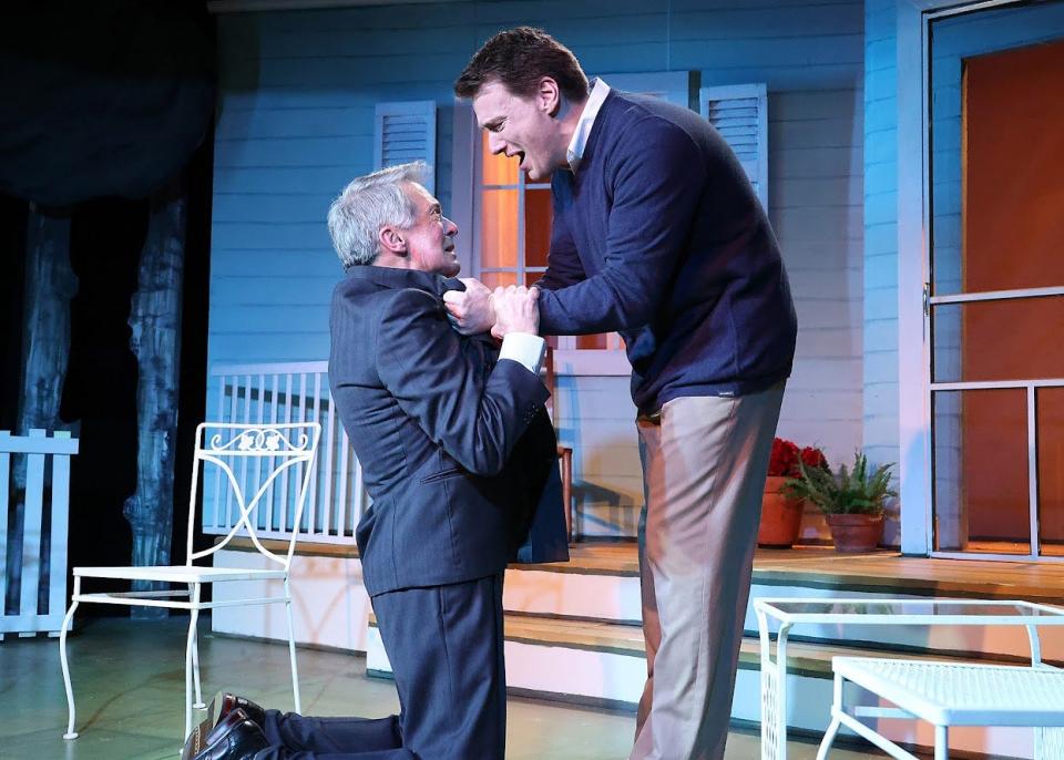 Mike Devine as Chris demands answers from his father, Joe, played by Nicholas Dorr, on his knees in Arthur Miller's "All My Sons."