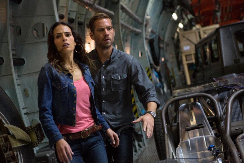 This film publicity image released by Universal Pictures shows Jordana Brewster, left, and Paul Walker in a scene from "Fast & Furious 6." (AP Photo/Universal Pictures, Giles Keyte)