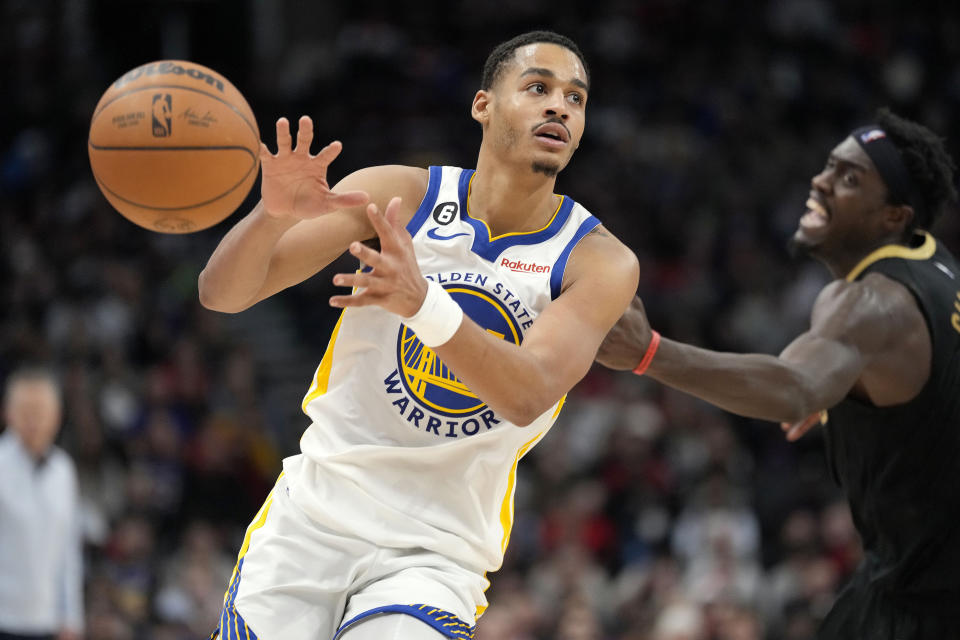 Golden State Warriors guard Jordan Poole (3) passes off the ball as Toronto Raptors forward Pascal Siakam (43) looks on during second-half NBA basketball game action in Toronto, Sunday, Dec. 18, 2022. (Frank Gunn/The Canadian Press via AP)