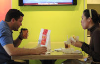 Carlos Gonzalez and Elsa Guzman ate breakfast at a McDonald's restaurant, Wednesday, Sept. 12, 2012 in New York. Gonzalez appreciated the new information. "It's good to know the calories I'm consuming so I can plan out my whole day," he said. (AP Photo/Mark Lennihan)