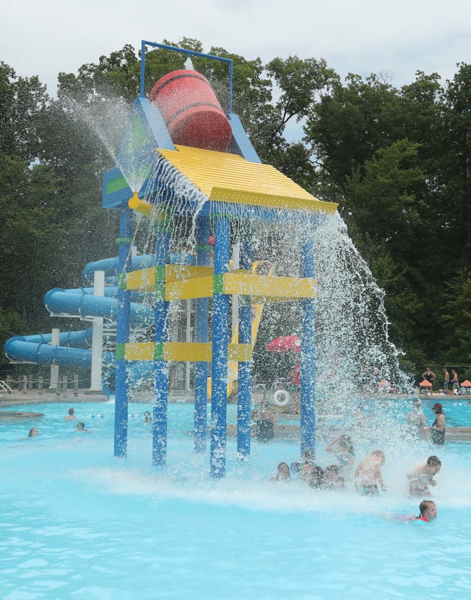 Children cool off in the large barrel splash zone at the Maca Aquatic Center in Tallmadge.