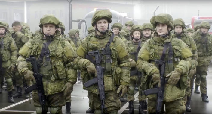 In this handout photo taken from video released by Russian Defense Ministry Press Service, Russian recruiters stand prior to their military training at the Patriot Park outside in Moscow, Russia, Saturday, Oct. 1, 2022. Russian President Vladimir Putin has ordered a partial mobilization of reservists to beef up his forces in Ukraine. (Russian Defense Ministry Press Service via AP)