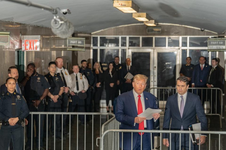 Donald Trump speaks to members of the media outside the courtroom on 10 May (EPA)