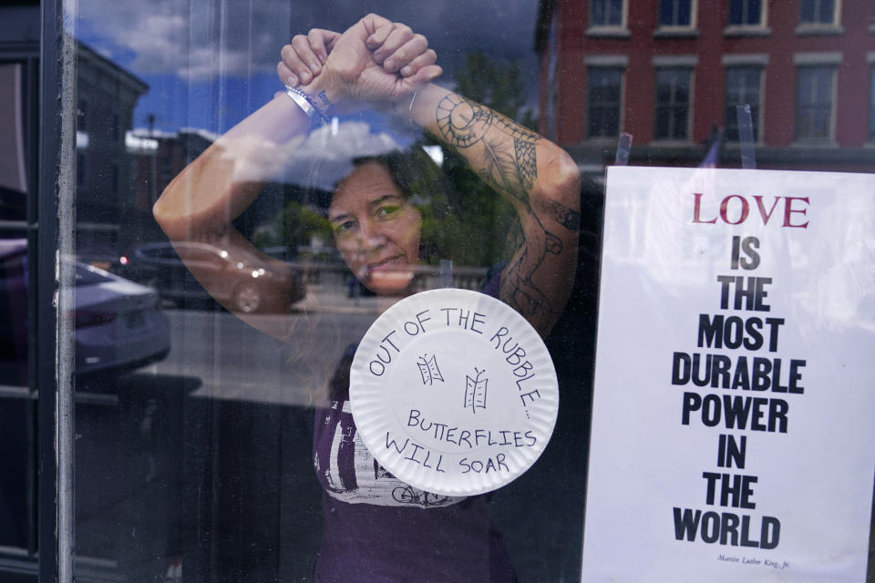 Jenny Sebold, owner of Rebel Heart gift store and Pink Shutter Flowers, poses in the storefront of her destroyed business, Tuesday, Aug. 1, 2023, in Montpelier, Vt. The mostly gutted shops, restaurants and businesses that lend downtown Montpelier its charm are considering where and how to rebuild in an era when extreme weather is occurring more often. Vermont's flooding was just one of several major flood events around the globe this summer that scientists have said are becoming more likely due to climate change. (AP Photo/Charles Krupa)