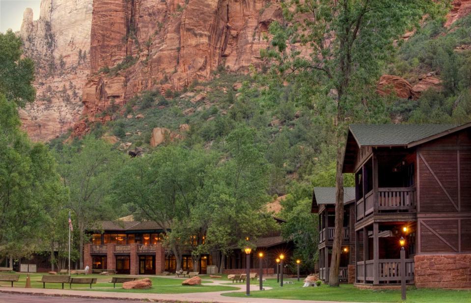 a building with a large rock cliff behind it