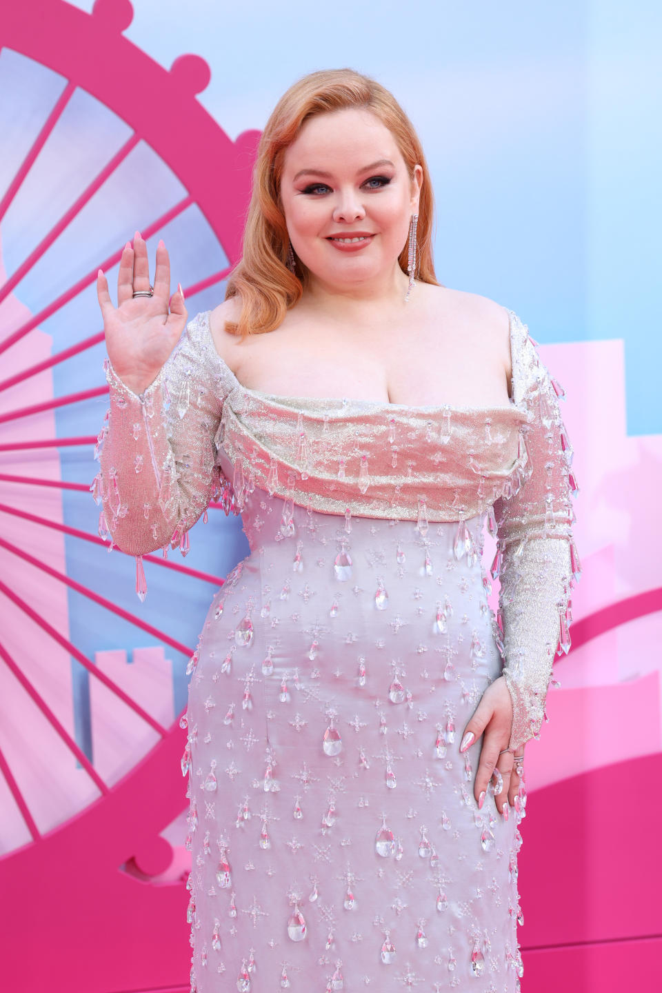 Closeup of Nicola Coughlan waving at the Barbie premiere