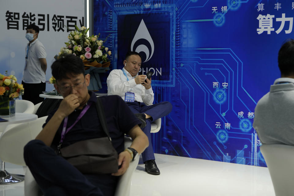 Visitors rest during a visit to the Security China 2023 expo in Beijing, on June 7, 2023. After years of breakneck growth, China's security and surveillance industry is now focused on shoring up its vulnerabilities to the United States and other outside actors, worried about risks posed by hackers, advances in artificial intelligence and pressure from rival governments. The renewed emphasis on self-reliance, combating fraud and hardening systems against hacking was on display at the recent Security China exhibition in Beijing. (AP Photo/Ng Han Guan)