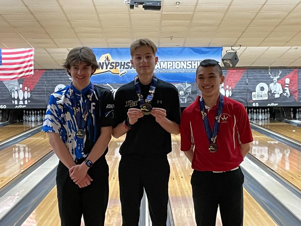 Rush-Henrietta's Keaton Ostrowski (center) won a gold medal for the highest average at the NYSPHSAA Bowling Championships.