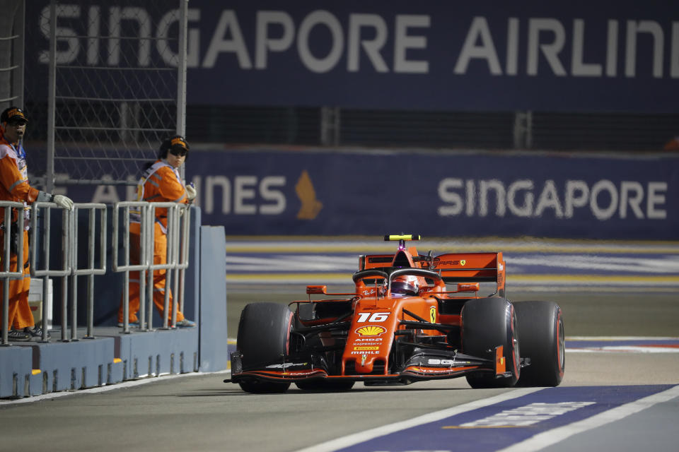 Ferrari driver Charles Leclerc of Monaco steers his car into pit-lane during the second practice session at the Marina Bay City Circuit ahead of the Singapore Formula One Grand Prix in Singapore, Friday, Sept. 20, 2019. (AP Photo/Vincent Thian)