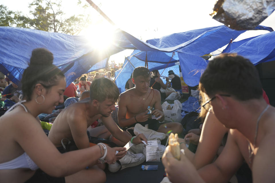 Young people flock together at the Parque Tejo in Lisbon for a vigil with Pope Francis, ahead of the 37th World Youth Day, Saturday, Aug. 5, 2023. On Sunday morning, the last day of his five-day trip to Portugal, Francis is to preside over a final, outdoor Mass on World Youth Day – when temperatures in Lisbon are expected to top 40 degrees C (104F) – before returning to the Vatican. (AP Photo/Ana Brigida)