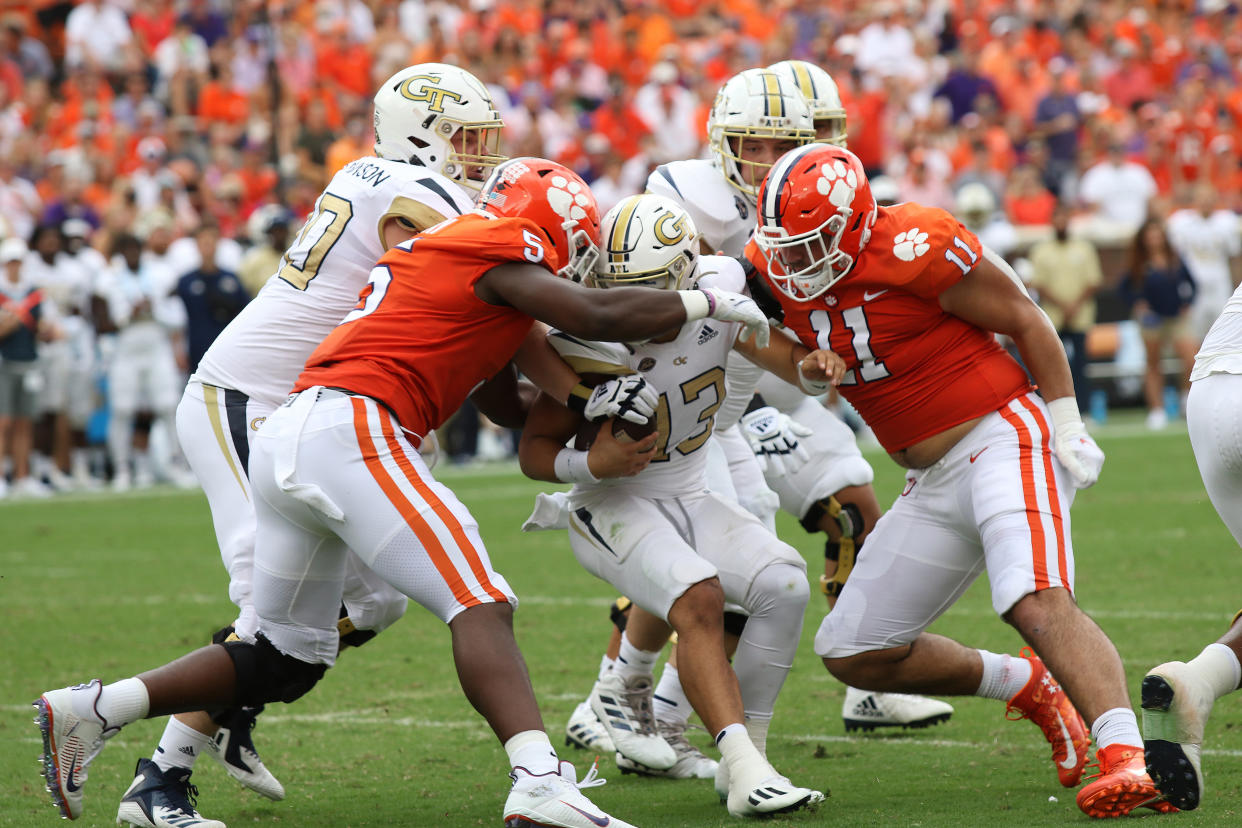 Clemson's K.J. Henry (5) and Bryan Bresee (11) come together to sack Georgia Tech's Jordan Yates (13) on Sept. 18, 2021. (John Byrum/Icon Sportswire)