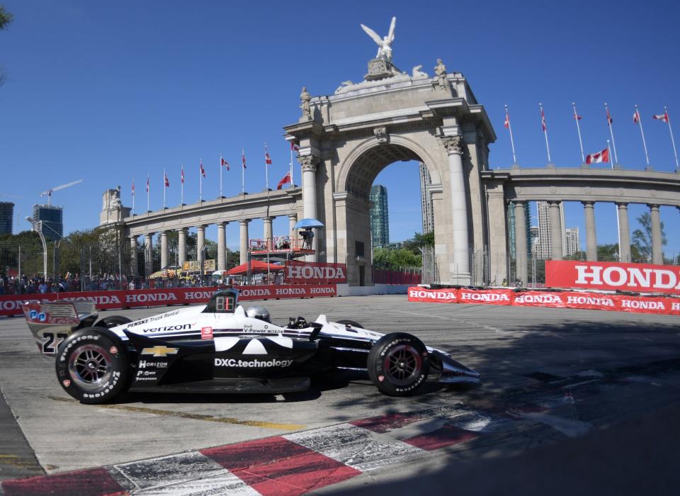 Jul 14, 2019; Toronto, Ontario, CAN; Indycar driver Simon Pagenaud (22) drives into turn one past the Princes Gates during the Honda Indy Toronto on the streets of Toronto.