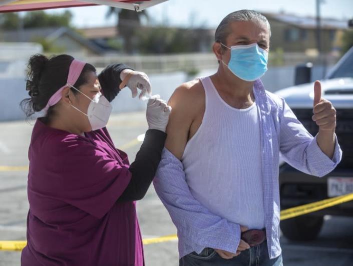 PACOIMA, CA - MARCH 04, 2021: Ponciano Sanchez, 57, of Pacoima, gives the thumbs up as he receives a vaccine shot from registered nurse Celeste Montoya at a COVID-19 vaccination pop-up site located at Valley Crossroads Seventh Day Adventist Church in Pacoima. Vaccination pop-up sites are being offered to residents of Los Angeles City Councilwoman Monica Rodriguez&#39;s district in the Northeast San Fernando Valley over the next three weeks. (Mel Melcon / Los Angeles Times)