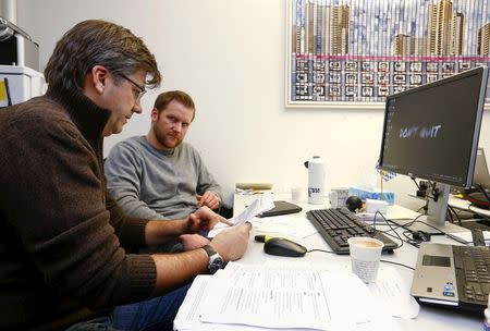 Employees work at the innovation lab of Swiss bank UBS in Zurich January 16, 2015. REUTERS/Arnd Wiegmann/Files