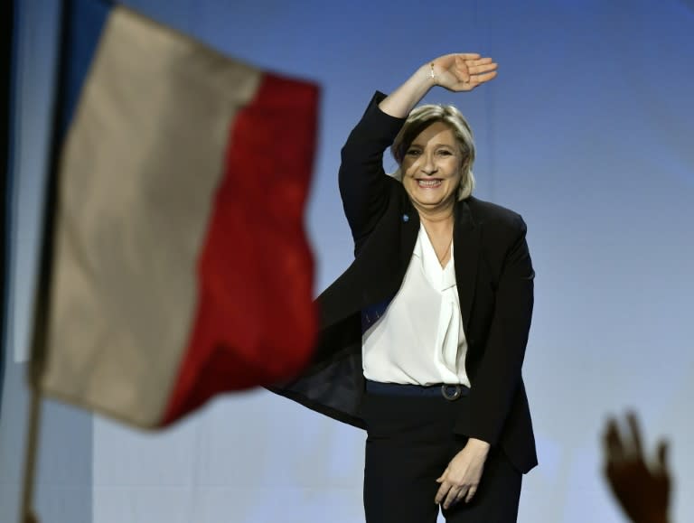 French presidential election candidate for the far-right Front National party Marine Le Pen waves as she arrives on stage to give a speech during a campaign meeting on April 2, 2017 at the Bordeaux-Lac exhibition center in Bordeaux, western France