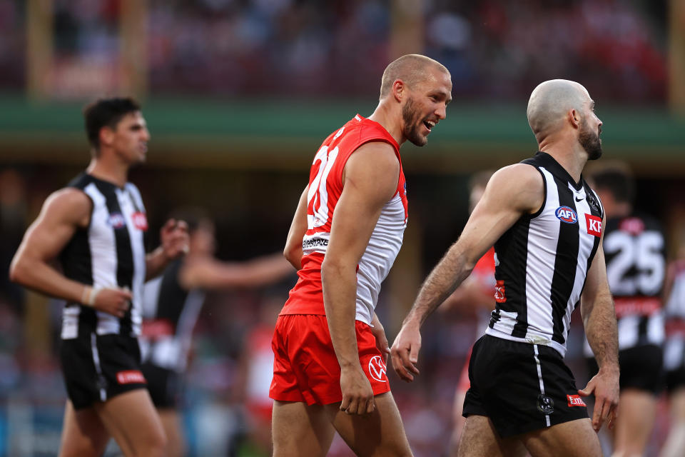 Sam Reid (pictured middle) reacts towards Steele Sidebottom (pictured right) during the AFL match.