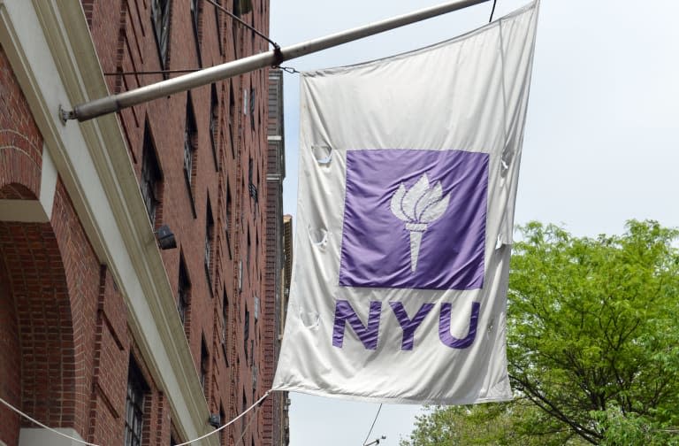 Flags fly from a New York University bui