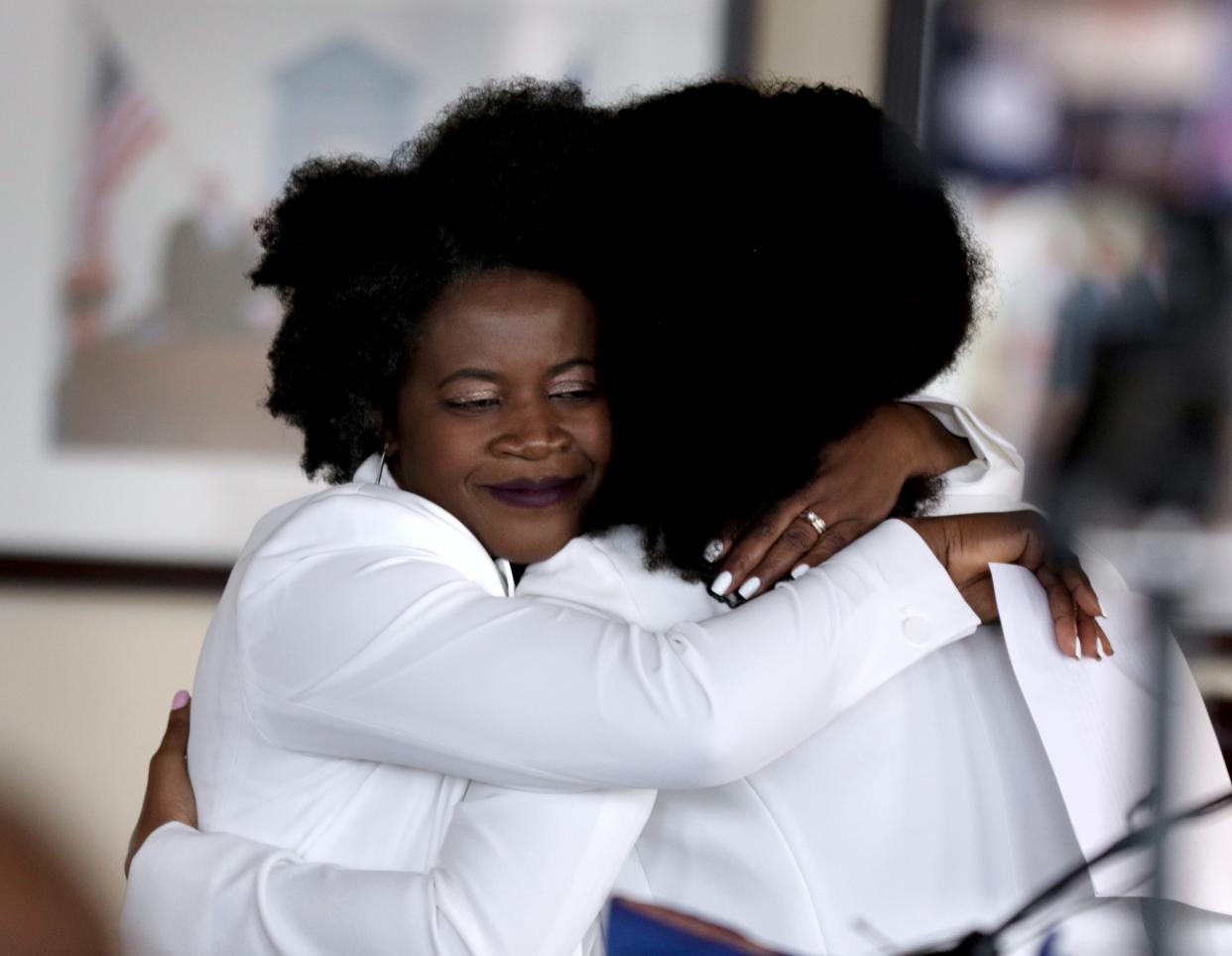 Then-Cranston Councilwoman Aniece Germain, left, hugs Kappy Bois during a Peace Memorial Vigil at Cranston City Hall in 2021 following the assasination of Haiti's president, Jovenel Moïse.