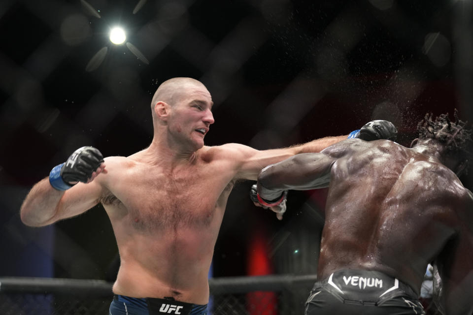 LAS VEGAS, NV - DECEMBER 17: (L-R) Sean Strickland punches Jared Cannonier in their Middleweight fight during the UFC Vegas 66 event at UFC APEX on December 17, 2022 in Las Vegas, Nevada, United States. (Photo by Louis Grasse/PxImages/Icon Sportswire via Getty Images)