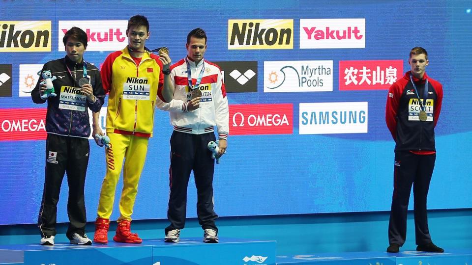 Duncan Scott emulates Mack Horton by standing away from Sun Yang during the medal ceremony. Pic: Getty