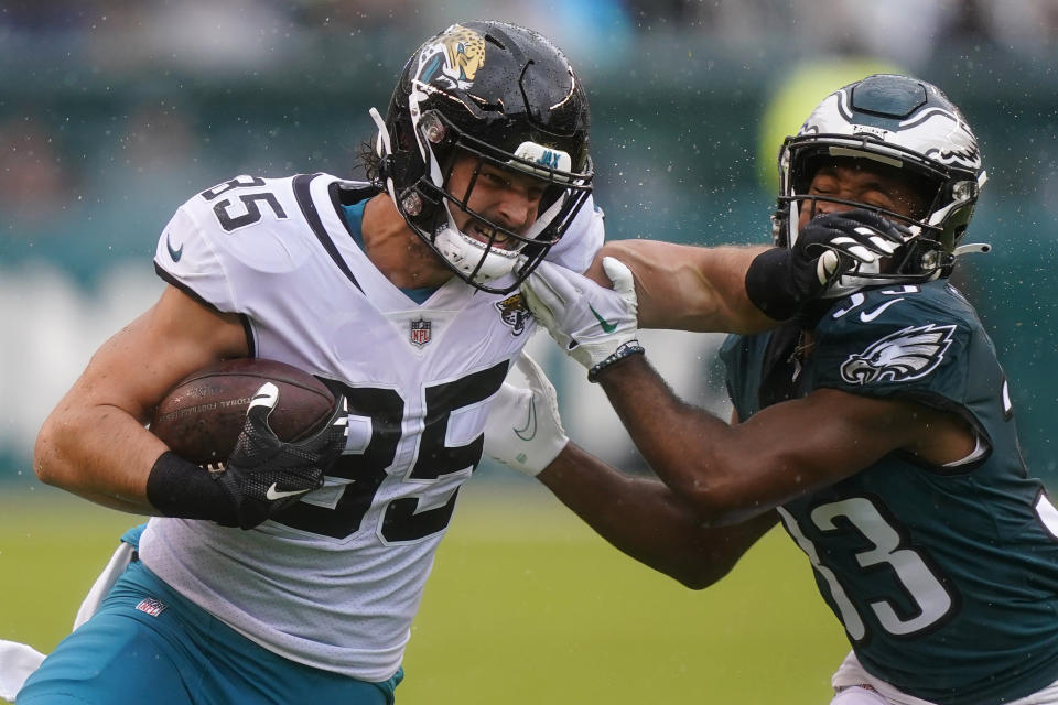 Jacksonville Jaguars' Dan Arnold, left, runs with the ball past Philadelphia Eagles' Josiah Scott on during the first half of an NFL football game Sunday, Oct. 2, 2022, in Philadelphia. (AP Photo/Matt Rourke)