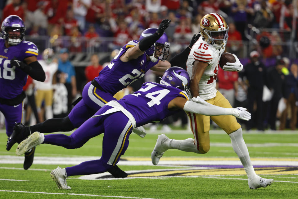 San Francisco 49ers wide receiver Jauan Jennings (15) runs Minnesota Vikings safety Harrison Smith (22) and safety Camryn Bynum (24) after catching a pass during the first half of an NFL football game, Monday, Oct. 23, 2023, in Minneapolis. (AP Photo/Bruce Kluckhohn)