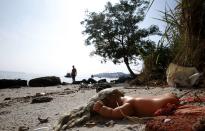 A toy doll is seen on Fundao beach in the Guanabara Bay in Rio de Janeiro March 13, 2014. REUTERS/Sergio Moraes