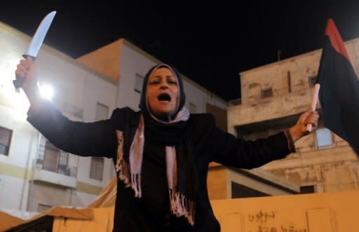 A woman celebrates in Benghazi last night after the United Nations Security Council voted to impose a no-fly zone over Libya