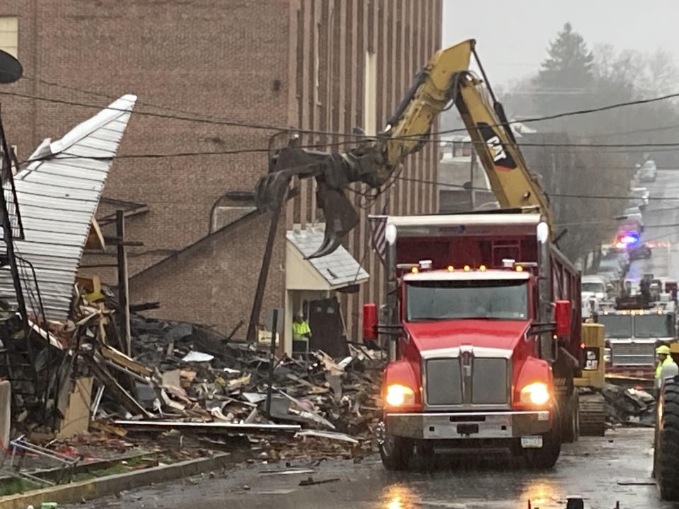 Rubble is cleared at the site of a deadly explosion at a chocolate factory in West Reading, Pa., Saturday, March 25, 2023. (AP Photo/Michael Rubinkam)