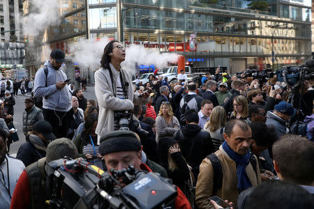 Members of the public and media are pictured outside the Time Warner Center in the Manahattan borough of New York City after a suspicious package was found inside the CNN Headquarters in New York, U.S., October 24, 2018. REUTERS/Kevin Coombs