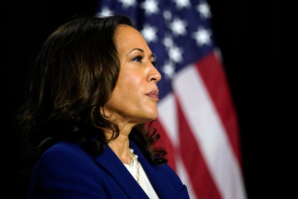 Sen. Kamala Harris, D-Calif., listens as Democratic presidential candidate former Vice President Joe Biden introduces her as his running mate at A.I. du Pont High School in Greenville on Wednesday, Aug. 12, 2020.