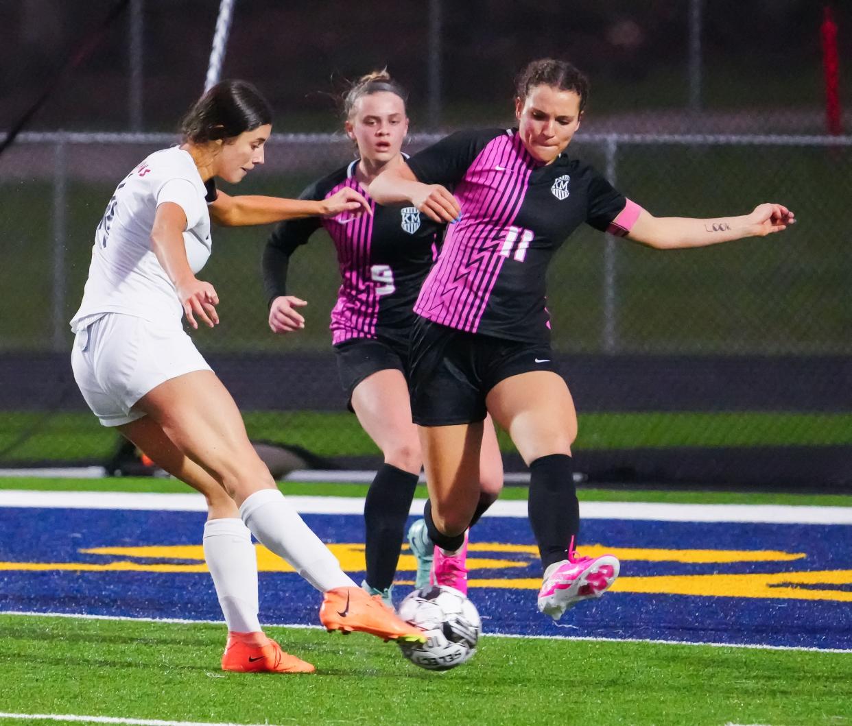 Kettle Moraine's Samantha Brown (11) deflects a shot by Brookfield East's Sara Multhauf during a match Thursday.