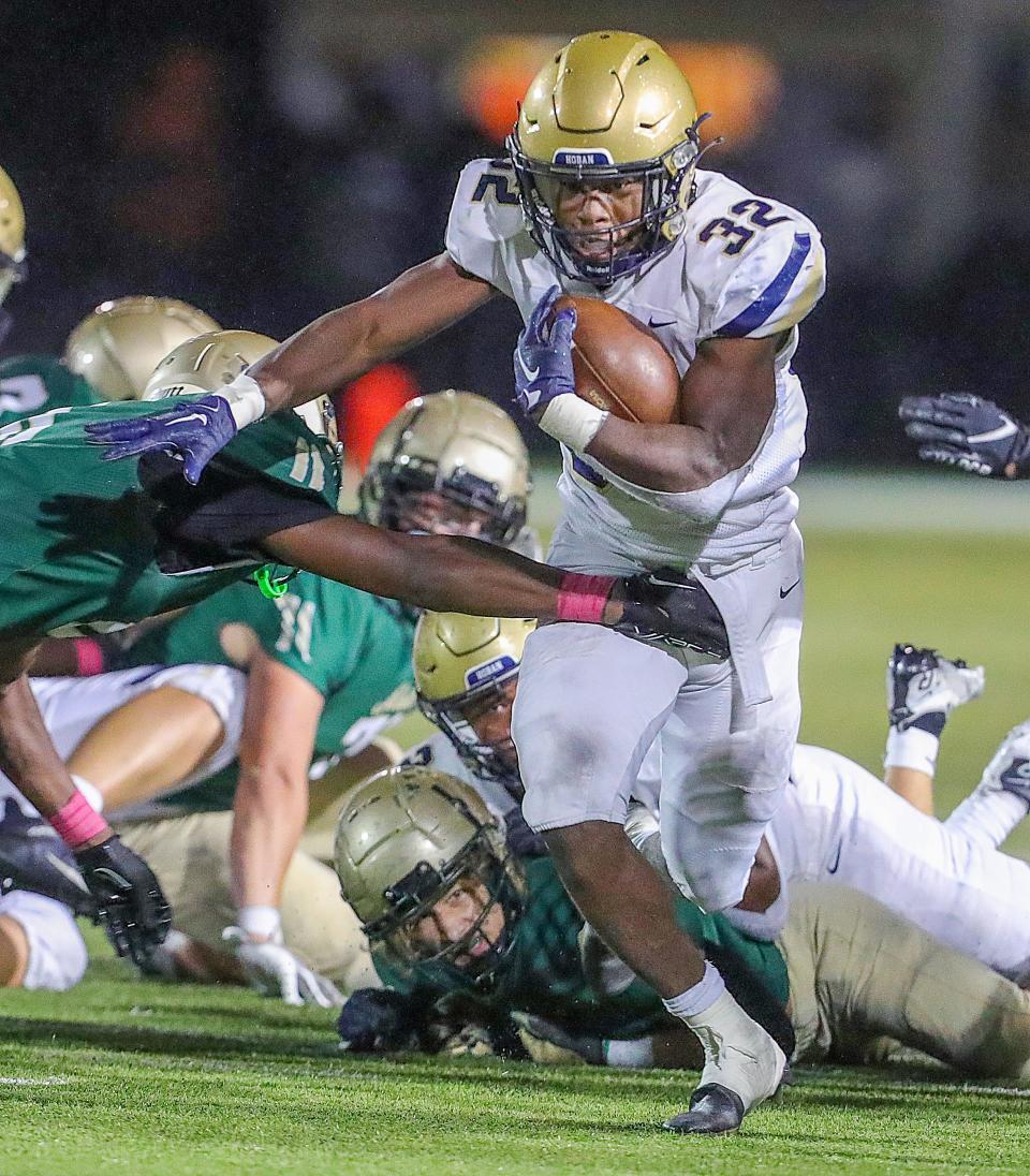Hoban's Lamar Sperling runs for yardage against  St. Vincent-St. Mary on Friday, Oct. 7, 2022 in Akron, Ohio, at John Cistone Field.