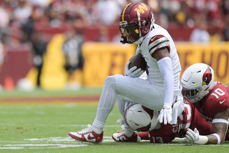 Washington Commanders wide receiver Jahan Dotson (1) catches a pass for a second down against the Arizona Cardinals at FedExField.