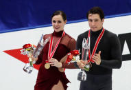 Figure Skating - ISU Grand Prix of Figure Skating NHK Trophy - Ice Dance Winners Ceremony - Osaka, Japan - November 12, 2017 - Winners Tessa Virtue and Scott Moir of Canada celebrate during the victory ceremony. REUTERS/Kim Kyung-Hoon