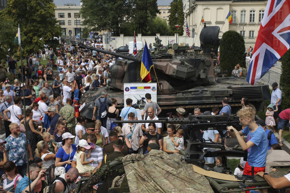 People attend a military picnic marking the Polish Army Day in Warsaw, Poland, Monday, Aug. 15, 2022. The Polish president and other officials marked their nation's Armed Forces Day holiday Monday alongside the U.S. army commander in Europe and regular American troops, a symbolic underlining of NATO support for members on the eastern front as Russia wages war nearby in Ukraine. (AP Photo/Michal Dyjuk)