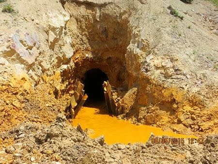 FILE PHOTO - Yellow mine waste water is seen at the entrance to the Gold King Mine in San Juan County, Colorado, U.S. in this picture released by the Environmental Protection Agency (EPA) taken on August 5, 2015. EPA/Handout via REUTERS