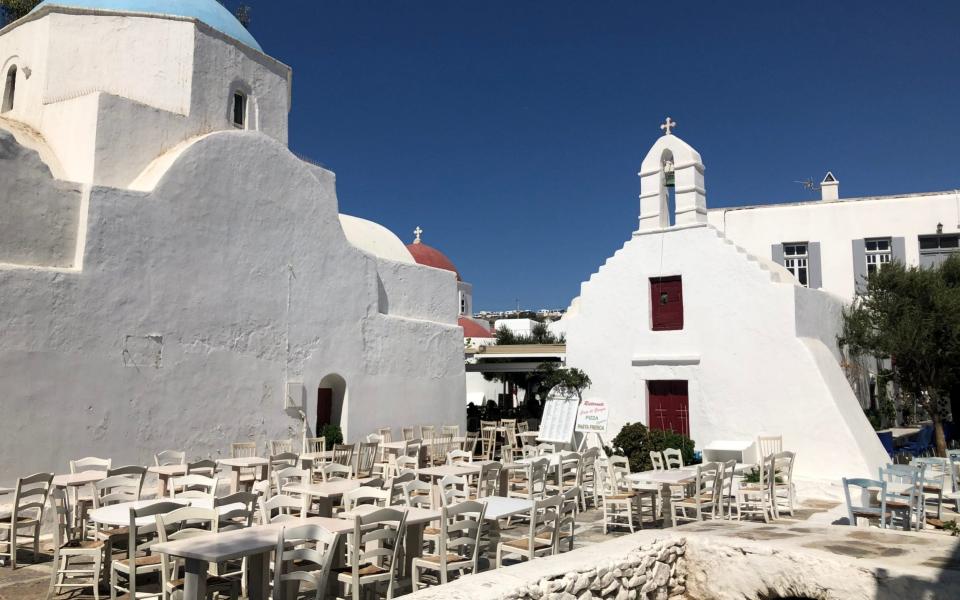 Empty tables greet the few tourist in Mykonos